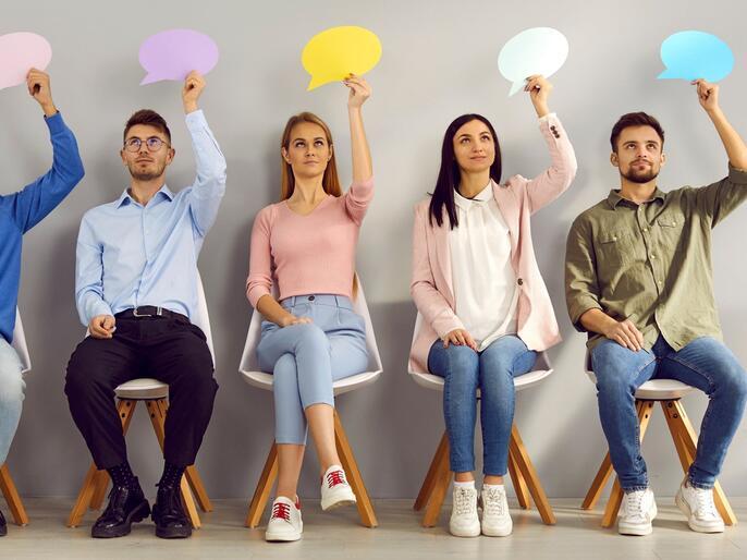Young people holding speaking bubbles
