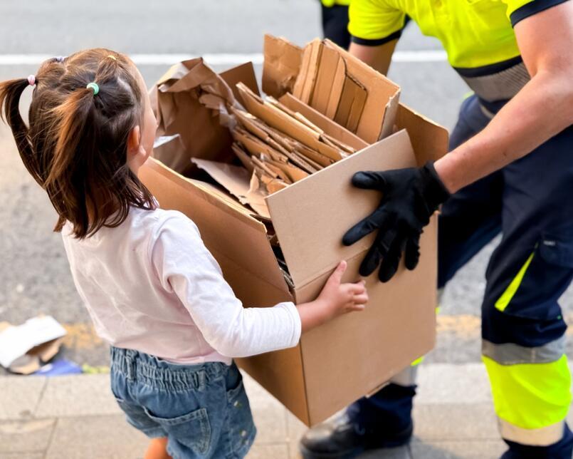 Young girl recycling cardboard