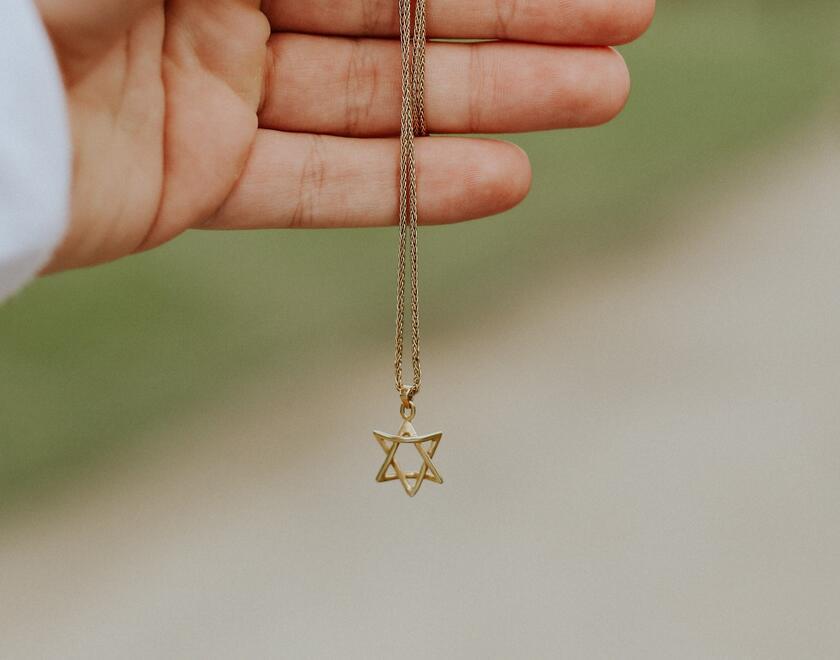 A hand holding a Star of David