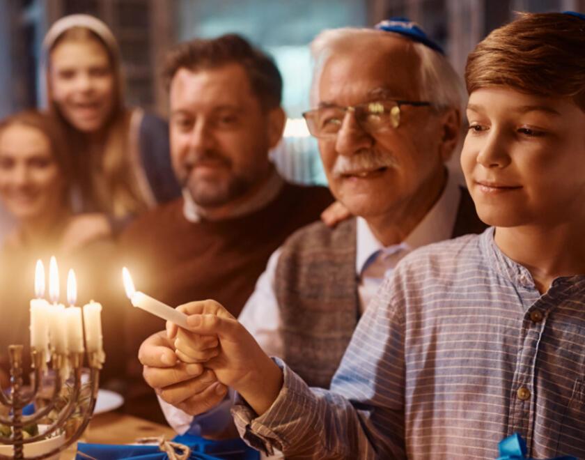 A Jewish family lights Hanukah candles