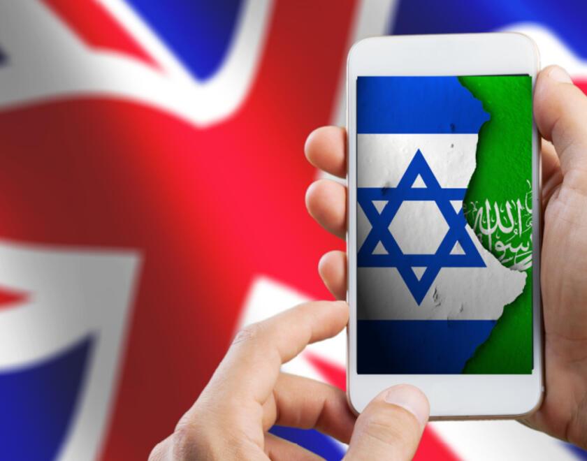 Mobile with Israel and Hamas flags over UK flag