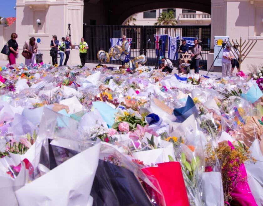 People gather at a memorial at Bondi Beach