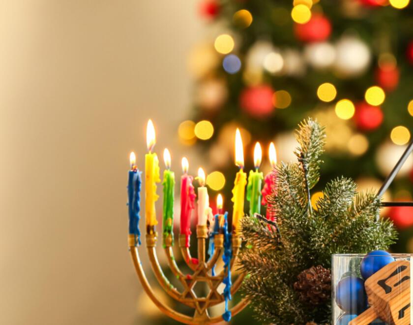 Chanukiah next to a Christmas tree