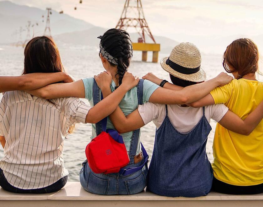 Friends of different races hug