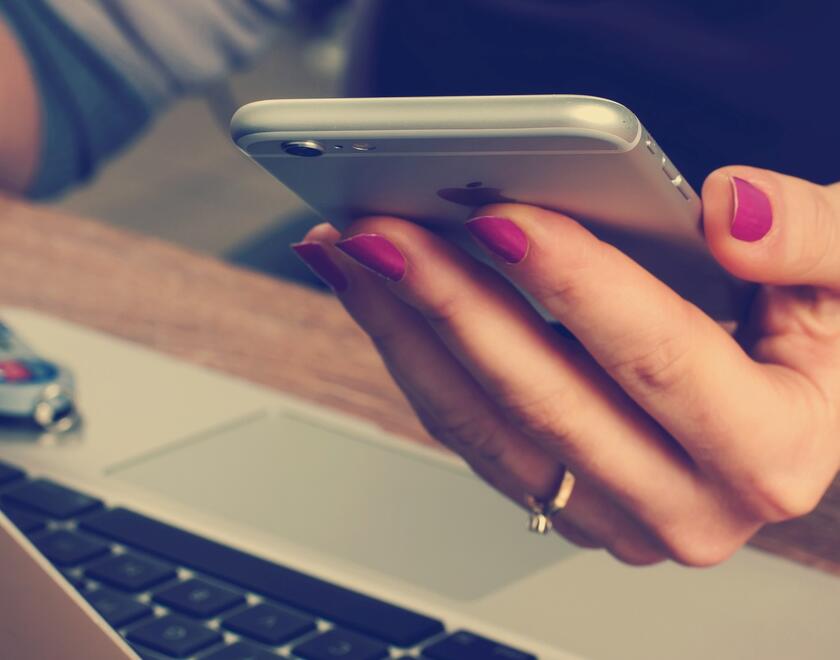 A hand holding a smartphone