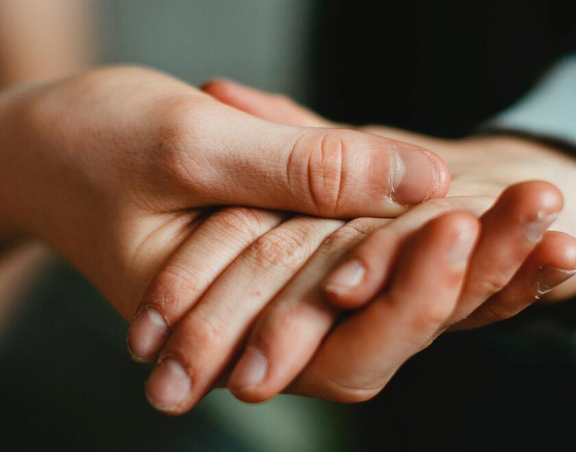 Volunteer helps an elderly woman