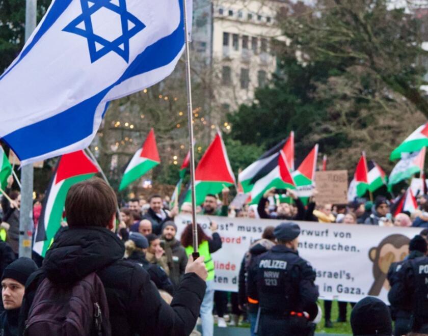 Israeli flag in front of a pro-Palestinian protest