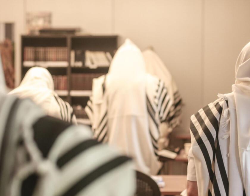 Jewish men praying in a synagogue