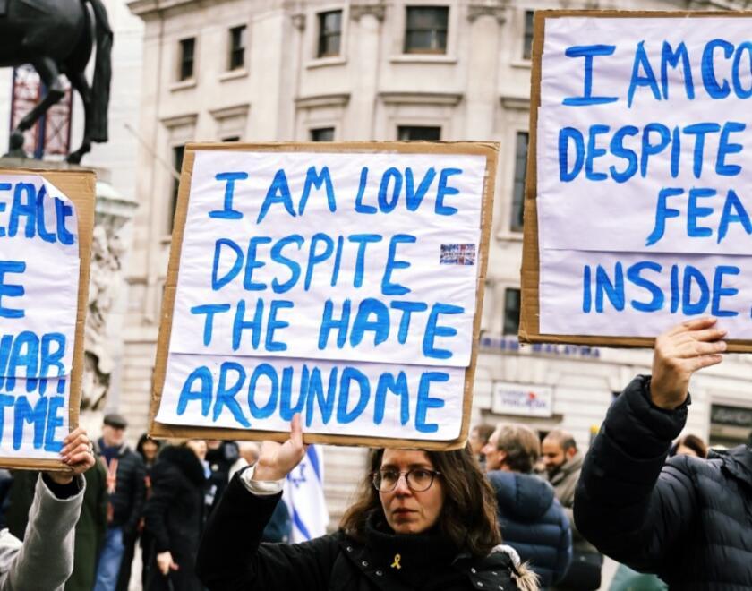 Jewish marchers against antisemitism holding optimistic signs 
