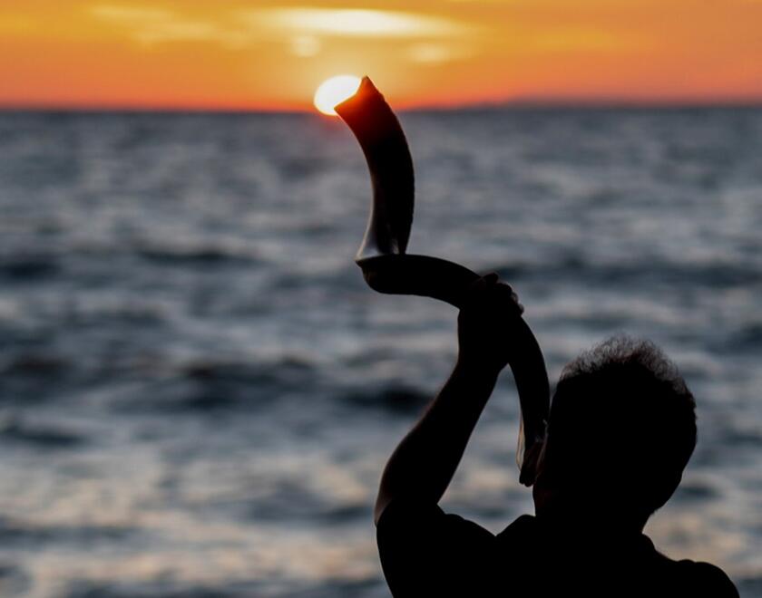 Man playing the Shofar on Yom Kippur