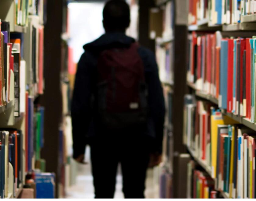 Student walking in a library