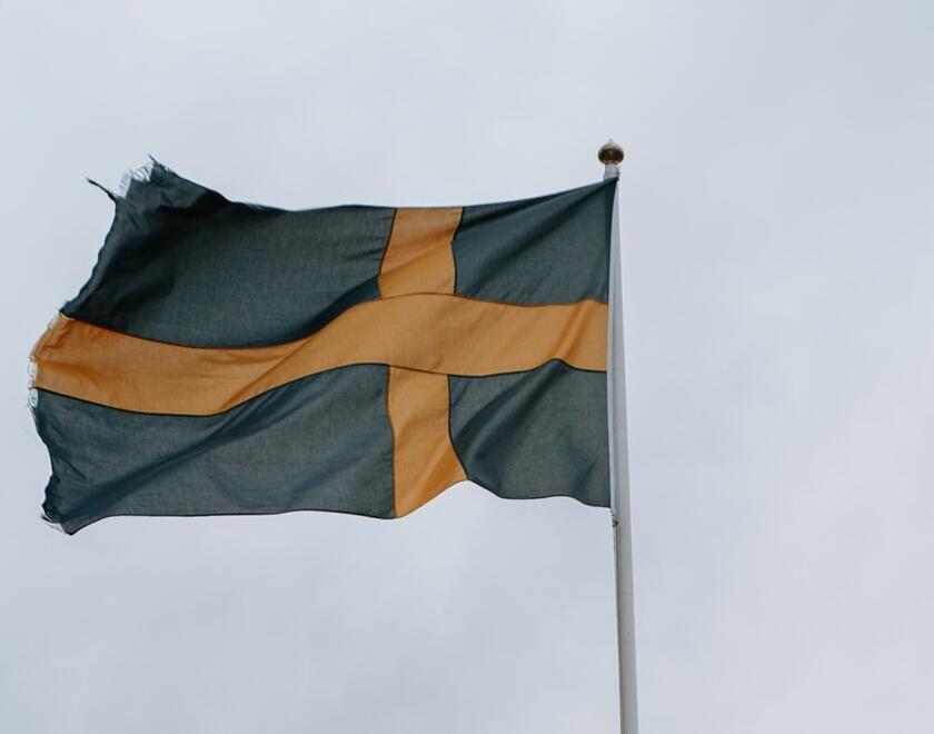 Flag of Sweden over a dark sky