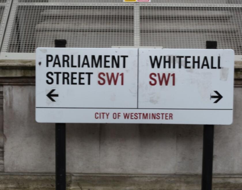 Street sign pointing to Parliament