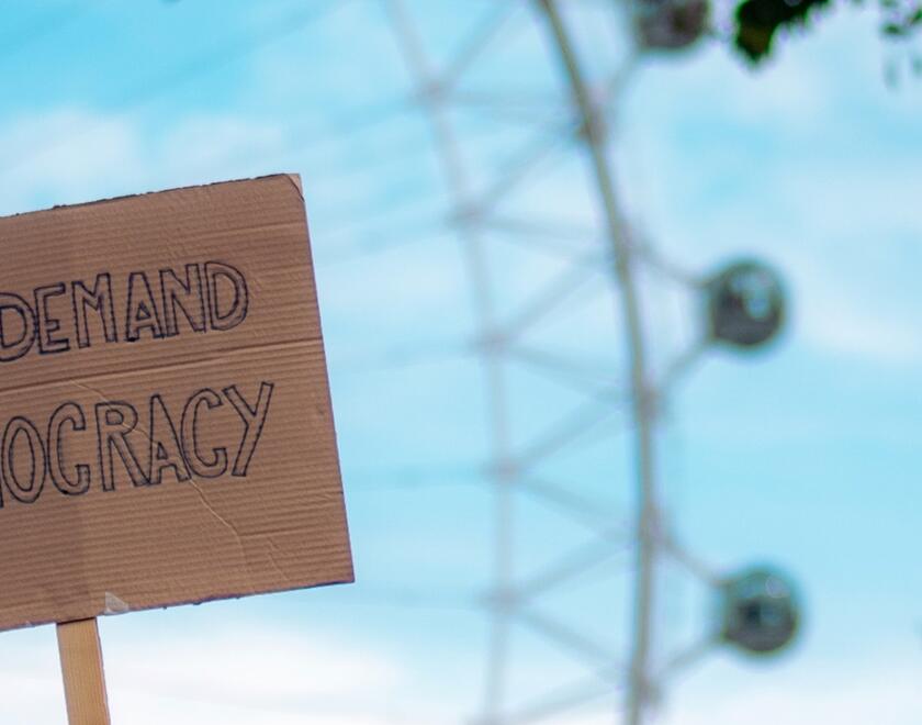 A sign sayin 'we demand democracy'